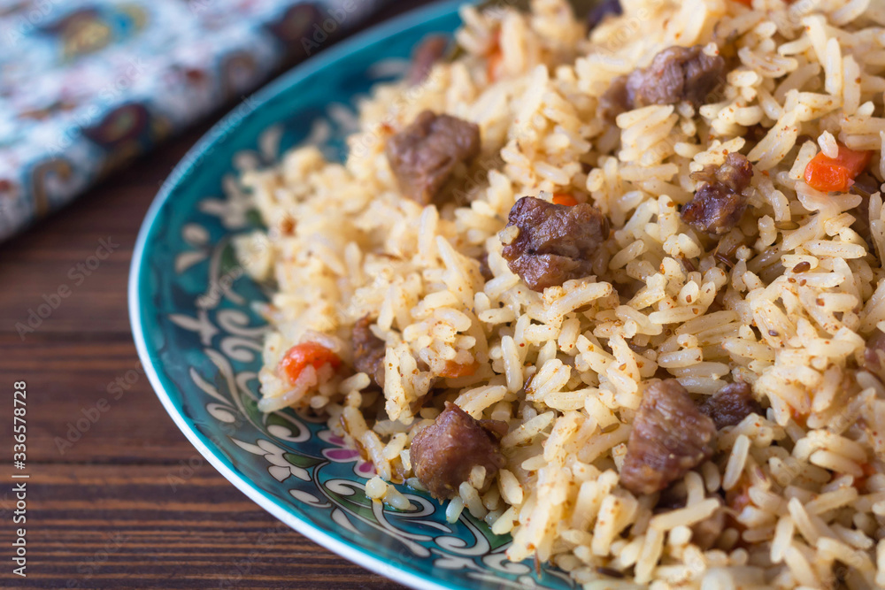 pilaf in a plate with a national pattern, Uzbek dishes, oriental cuisine, close-up pilaf in a plate with a national pattern, Uzbek dishes, oriental cuisine, close-up