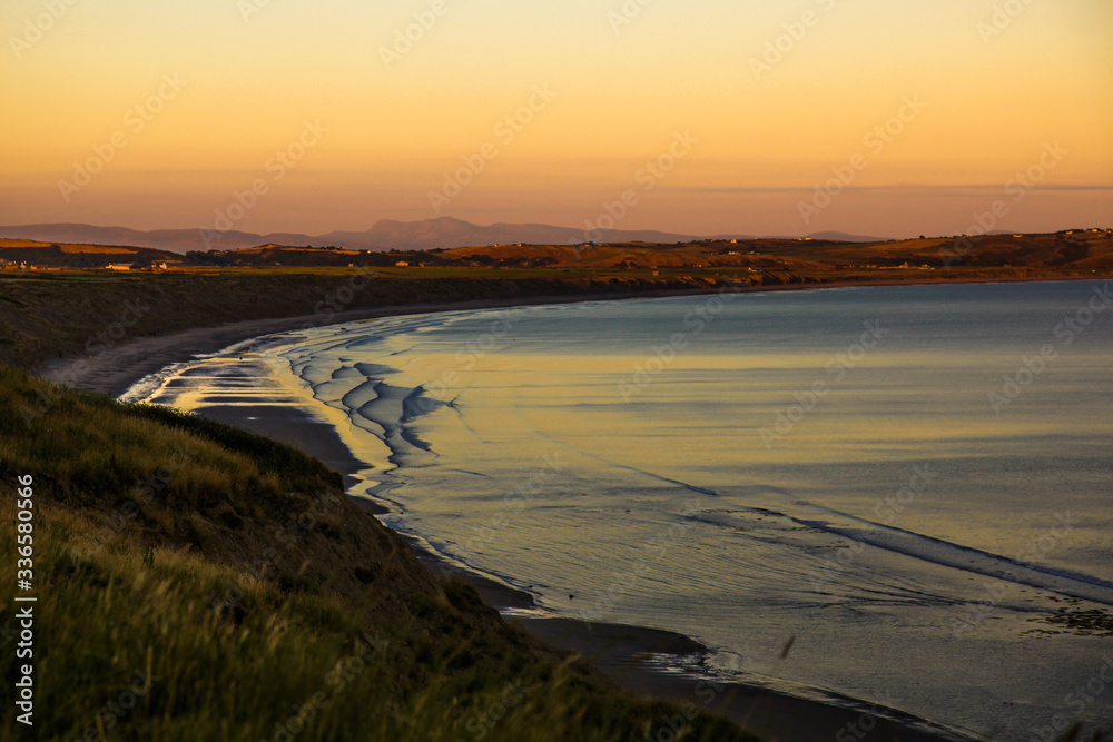 Fototapeta premium Sun set over Hell's Mouth, Wales, UK