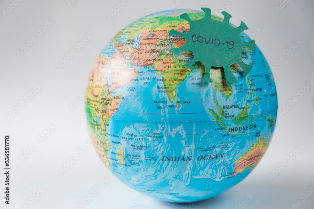 Naklejka premium Pandemic Covid-19. Globe with the coronavarus virus on a white background. The concept of a global epidemic.