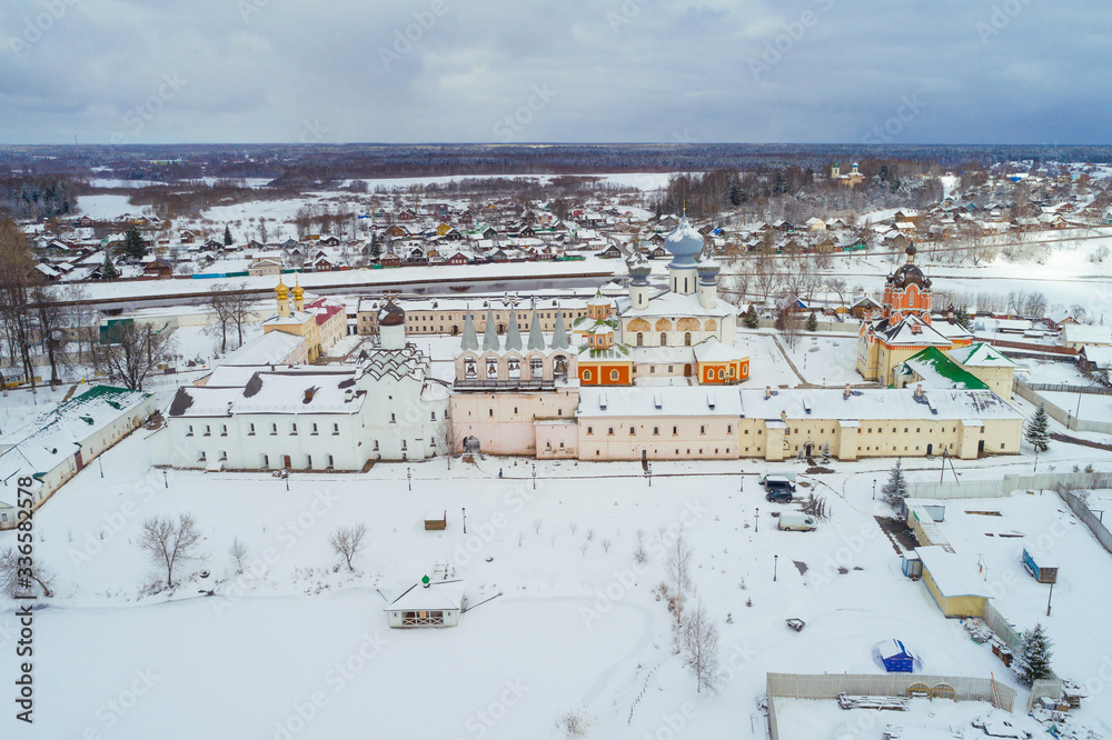 View of the Tikhvin Mother of God Assumption Monastery on a cloudy March day (shot from a drone). Leningrad region, Russia: