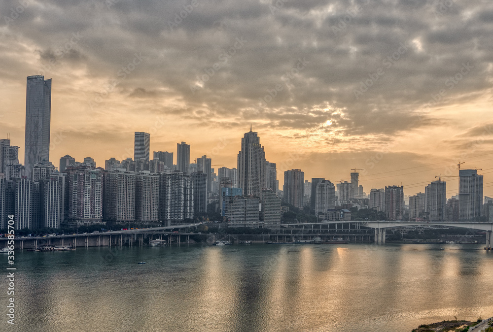 Sunset over Jialing river with dense residence buiding in Chongqing, China