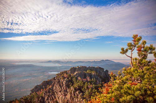 Epic view from the highest point of Sinyuha Mountain in autumn season in Burabay, Kazakhstan. Approach of the cyclone, the movement of low clouds over the forest photo