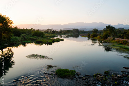 Fototapeta Naklejka Na Ścianę i Meble -  The calm river at sunset