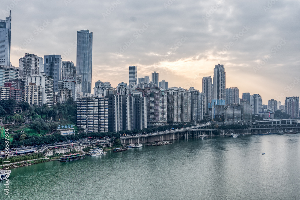 Fototapeta premium Sunset over Jialing river with dense residence buiding in Chongqing, China