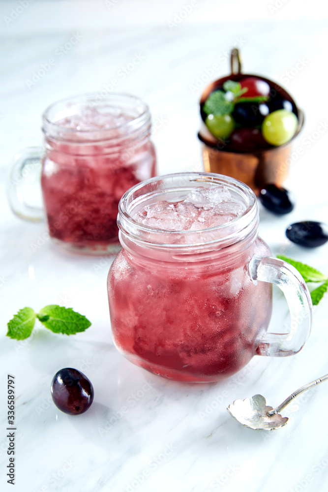 Red Cocktail with mint and ice, selective focus