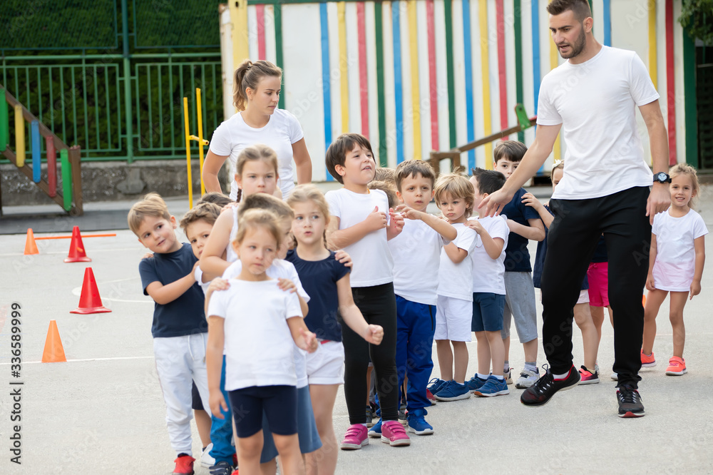 Group of children standing in column and waiting for lesson start. Sport school Group of children standing in column and waiting for lesson start. Sport school