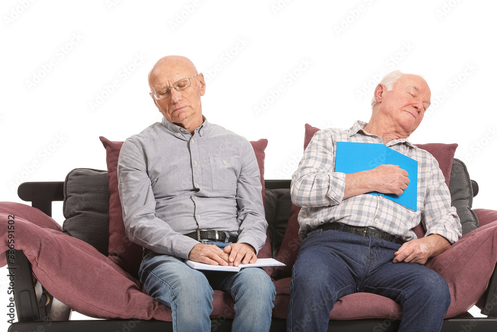 Portrait of sleeping elderly men with books on white background Portrait of sleeping elderly men with books on white background