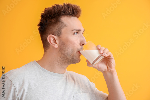 Young man with milk on colo...