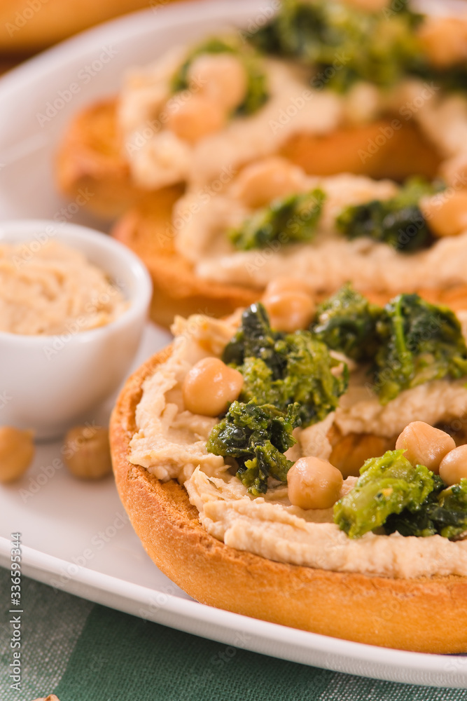 Friselle with turnip tops and hummus.
Friselle with turnip tops and hummus.