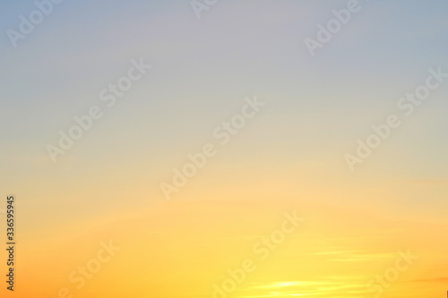 Sun below the horizon and fiery dramatic orange sky at sunset or dawn backlit by the sun. Place for text and design. © Stanislav