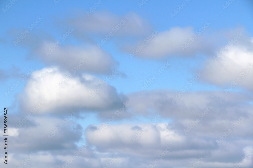 Lovely white fluffy clouds on a background of blue sky.