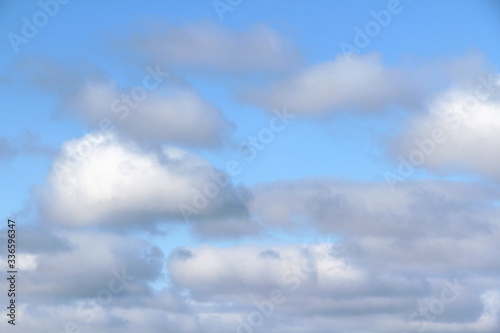 Lovely white fluffy clouds on a background of blue sky. © Stanislav