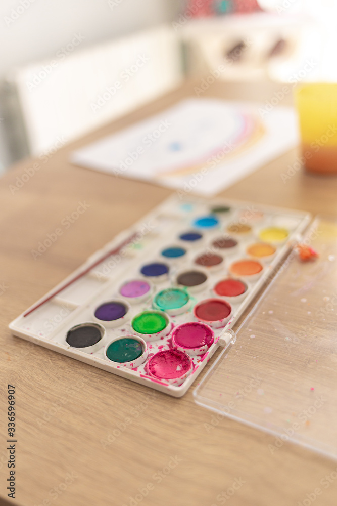 Coloful watercolor painting pots on a hardwood table for playing with kids Coloful watercolor painting pots on a hardwood table for playing with kids