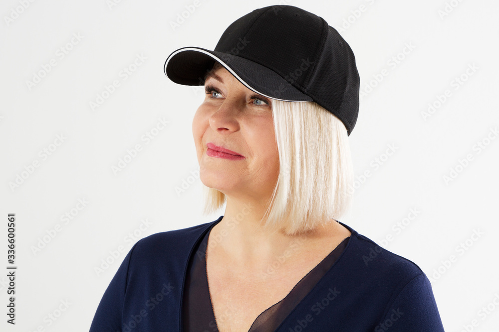 Middle age woman in blank black hat blazer isolated close up, beautiful and fashion middle-aged woman portrait, female with black cap isolated on a light Middle age woman in blank black hat blazer isolated close up, beautiful and fashion middle-aged woman portrait, female with black cap isolated on a light