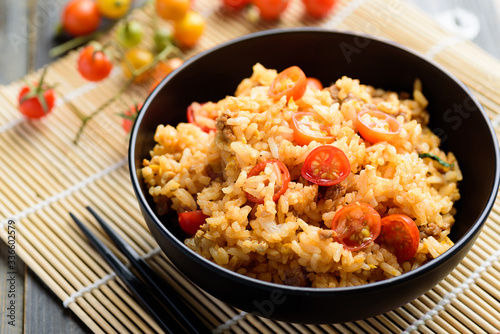 Fried rice with minced pork and tomato in a bowl and chopsticks ready to eating, Asian food