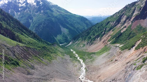 Caucasus Mountains on the border of Russia and Georgia. Chalaat Pass and Very beautiful view of the Chalaadi Glacier, Mount Ushba and Mestiachala river with background of clear blue sky. photo