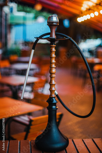 Stylish wooden hookah in the evening on a summer terrace in a cafe © prokop.photo