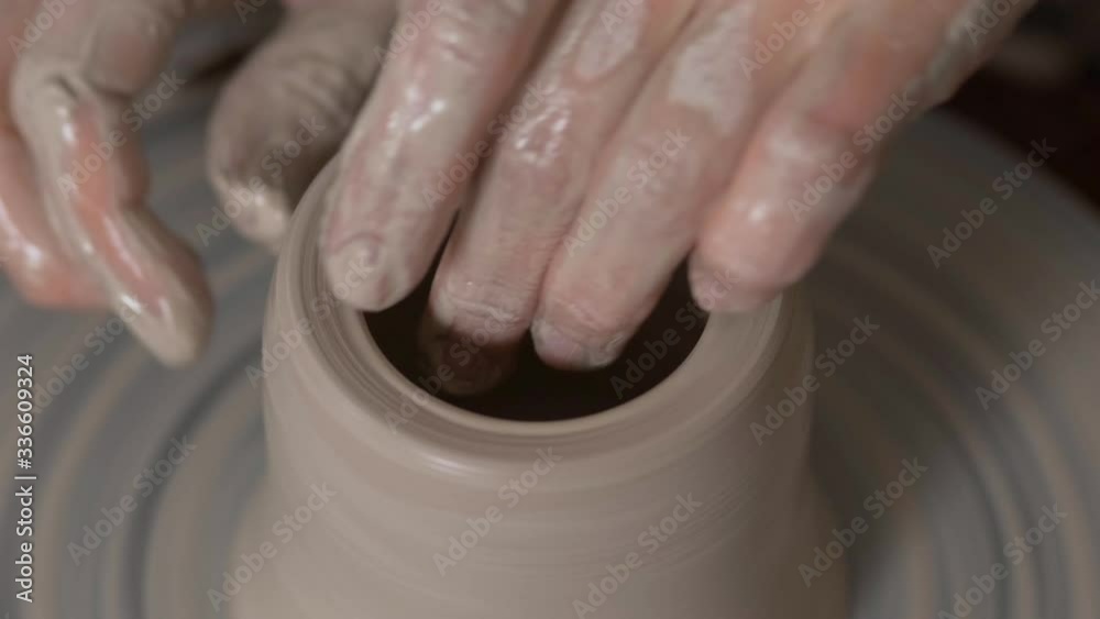 Wet hands. Wet pottery on a Potter's wheel. Work on the creation of the cavity of the product. The work of the Potter Wet hands. Wet pottery on a Potter's wheel. Work on the creation of the cavity of the product. The work of the Potter