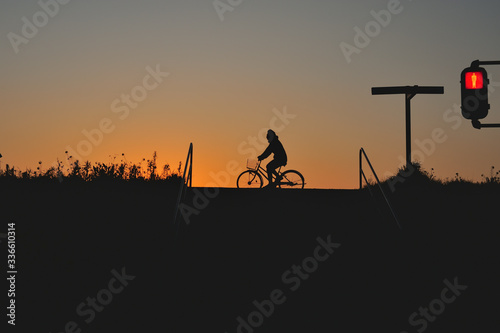 silhouette of a man riding on bicycle