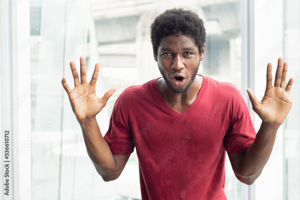 happy man with success; portrait of happy smiling excited strong successful African black man expression excitement and looking at you; young adult African black man model