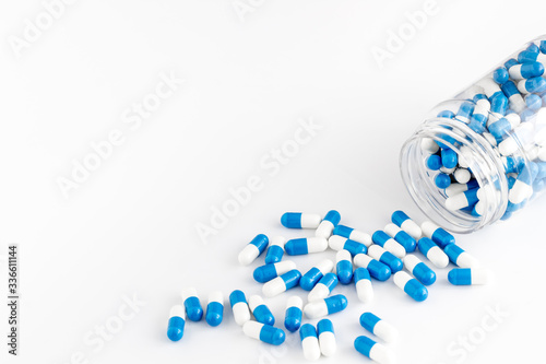 Creatine capsules. Pills scattered on white background copy space
