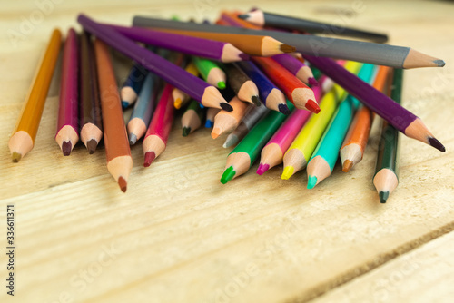 colored pencils on a wooden background,close-up