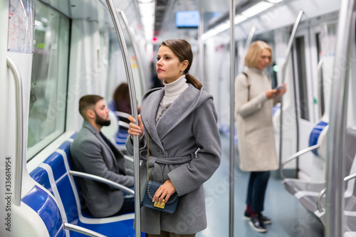 Young brunette traveling by subway car
