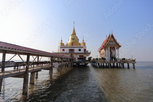 Gold pagoda and church located in the sea at Hong Thong Temple, Chachoengsao, Thailand
