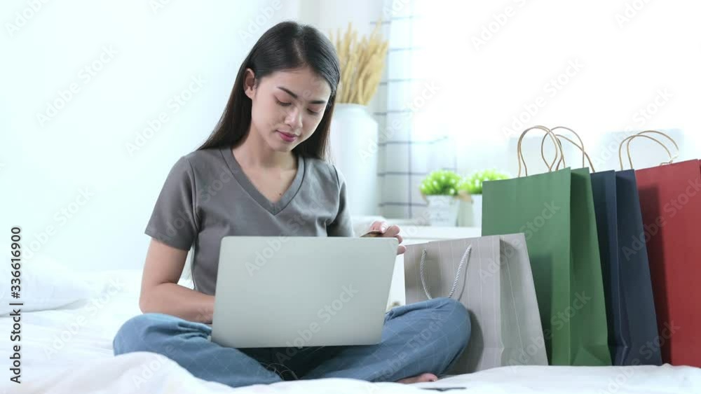Beautiful young asian woman in grey T-shirt are working with video calling by laptop with her team for social distancing policy. Self quarantine, coronavirus, work from home concept Beautiful young asian woman in grey T-shirt are working with video calling by laptop with her team for social distancing policy. Self quarantine, coronavirus, work from home concept