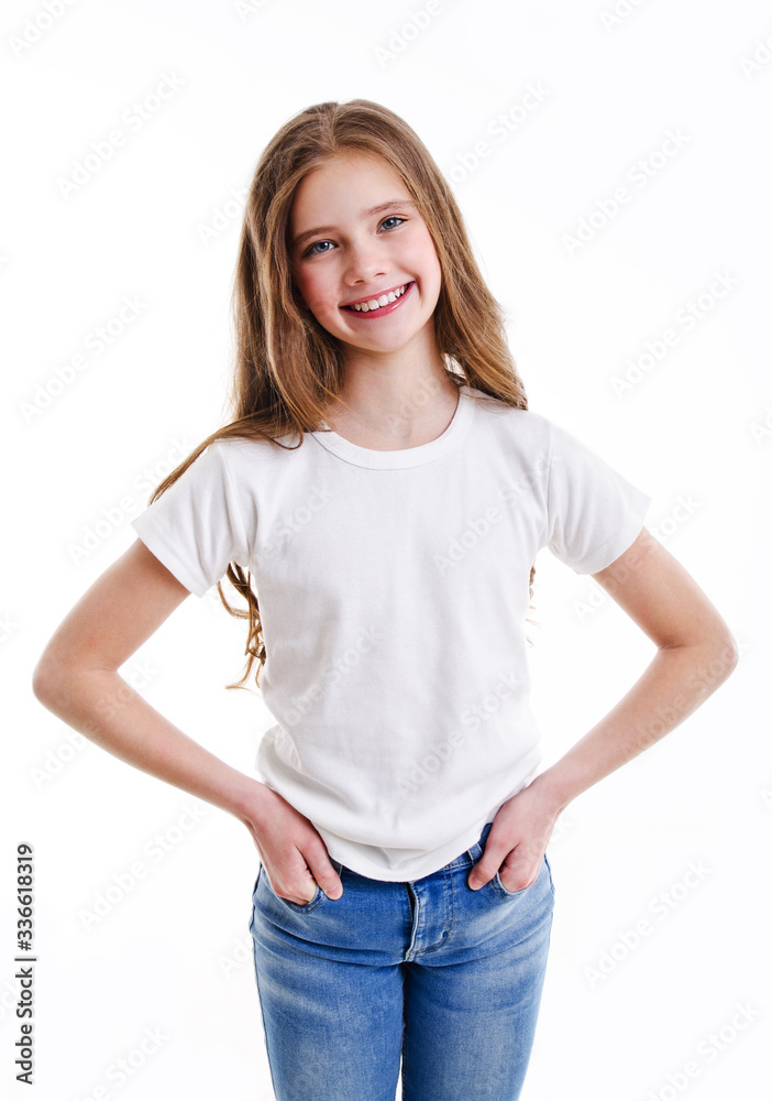 Portrait of adorable smiling little girl child preteen in jeans and white t- shirt isolated Stock Photo | Adobe Stock