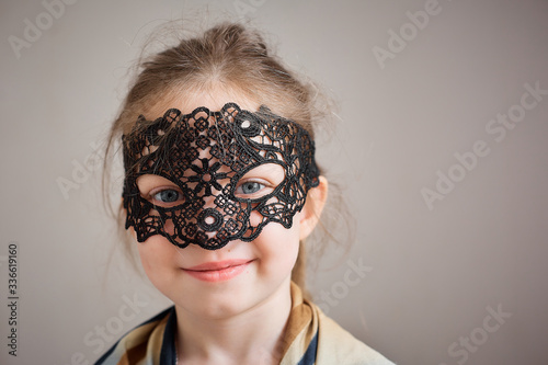 little girl in a vintage fishnet mask
