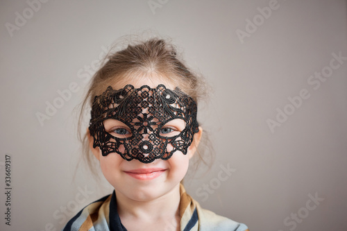 little girl in a vintage fishnet mask