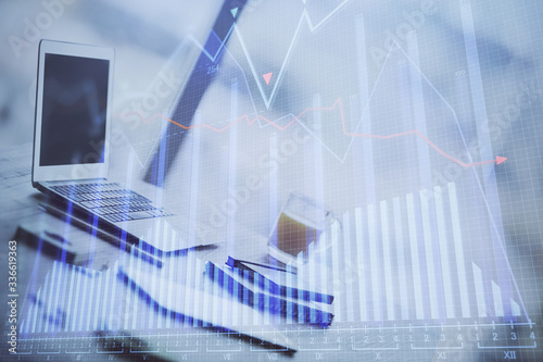 Stock market graph and table with computer background. Double exposure. Concept of financial analysis.