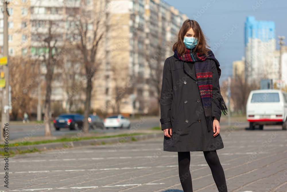 Young Girl on the city street wearing face mask protective for spreading of disease virus SARS-CoV-2