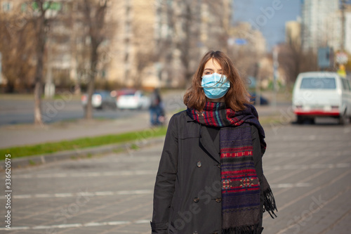 Young Girl on the city street wearing face mask protective for spreading of disease virus SARS-CoV-2 © merydolla