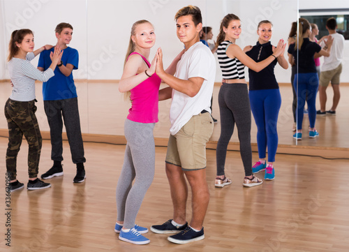 Group of teenagers dancing tango in dance studio