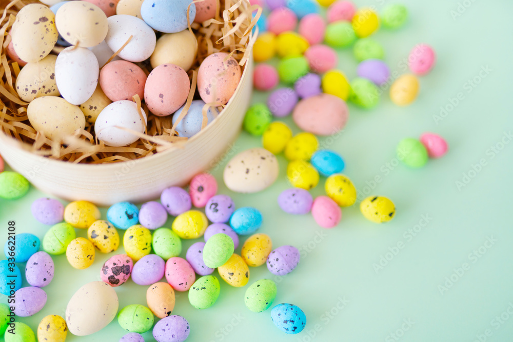 From above colorful quail eggs placed in nest made of shredded paper in pot during Easter celebration From above colorful quail eggs placed in nest made of shredded paper in pot during Easter celebration