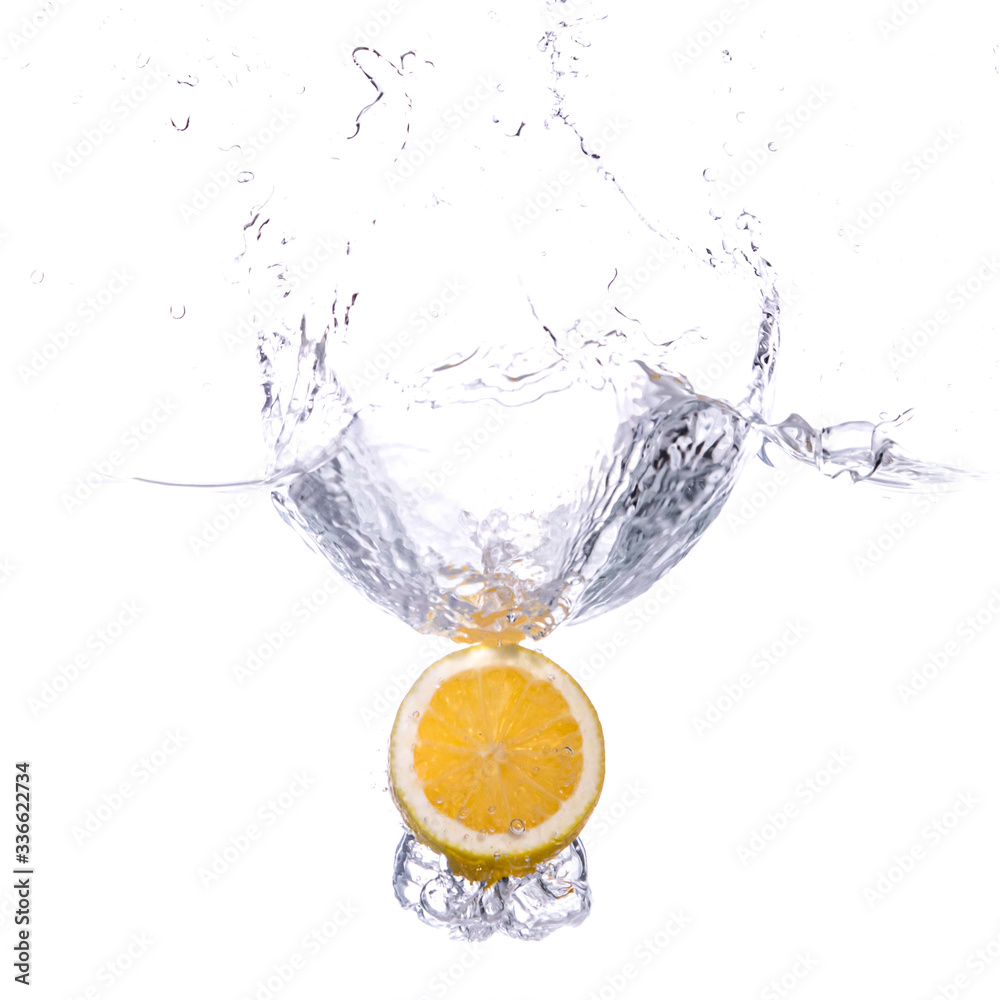 Water Splash Photography: an Lemon fruit falling in water creating a large splash, on a white background