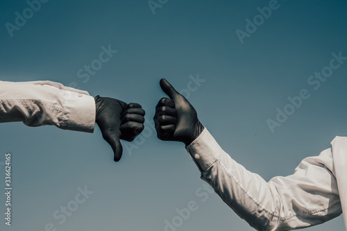 Black latex medical gloves on a male hand, shows the characters or symbols. © Inception
