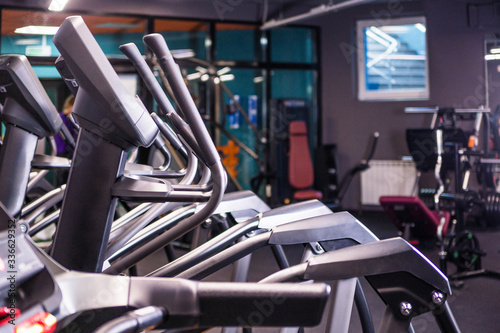 Modern ellipsoid trainer in a dark gym