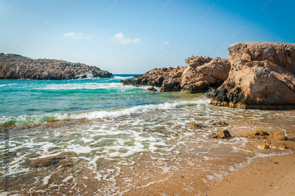 A photo of a greek beach with rock formations. Summer vacation concept. Kos island, Greece