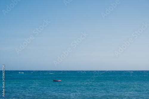 Wooden small boat in the sea landscape with endless horizon © Nickolay Khoroshkov
