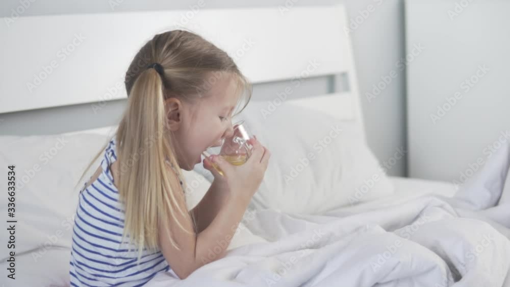 Concept. A nice little girl drinks tea with lemon in the hospital. Concept. A nice little girl drinks tea with lemon in the hospital.