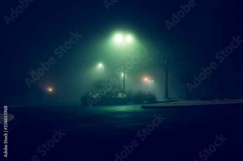 Street lights foggy misty night lamp post lanterns at empty city