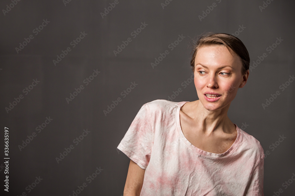 Happy cheerful young woman with short hair, natural makeup over grey background. Indoor portrait of beautiful brunette young woman Happy cheerful young woman with short hair, natural makeup over grey background. Indoor portrait of beautiful brunette young woman