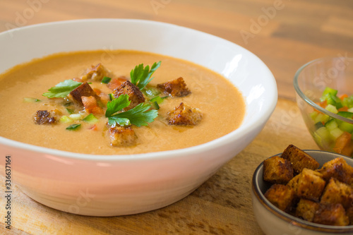 Food photography of a chilled Spanish gazpacho soup in a white bowl.