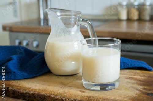 Food photography of a pitcher and glass with the Japanese drink Calpis or Calpico with a blue cloth on modern kitchen background. photo