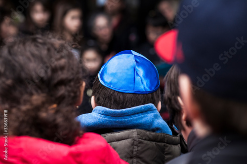 Jewish children gathering during a Stolpersteine memorial ceremony.	