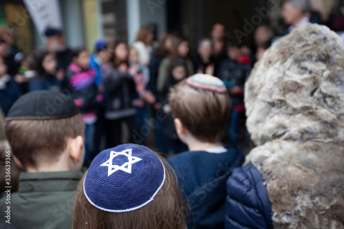 Jewish children gathering during a Stolpersteine memorial ceremony.	