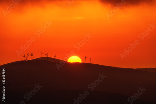 Windmills  at the the top of a mountain in a stunning sunset
